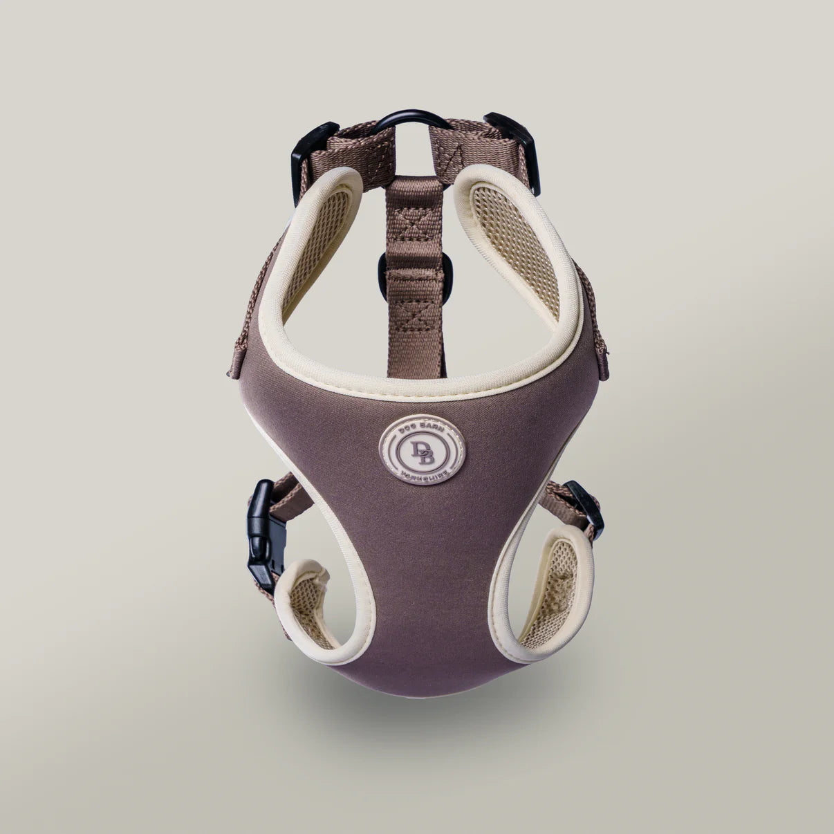 Dog harness with brand logo on a light gray background