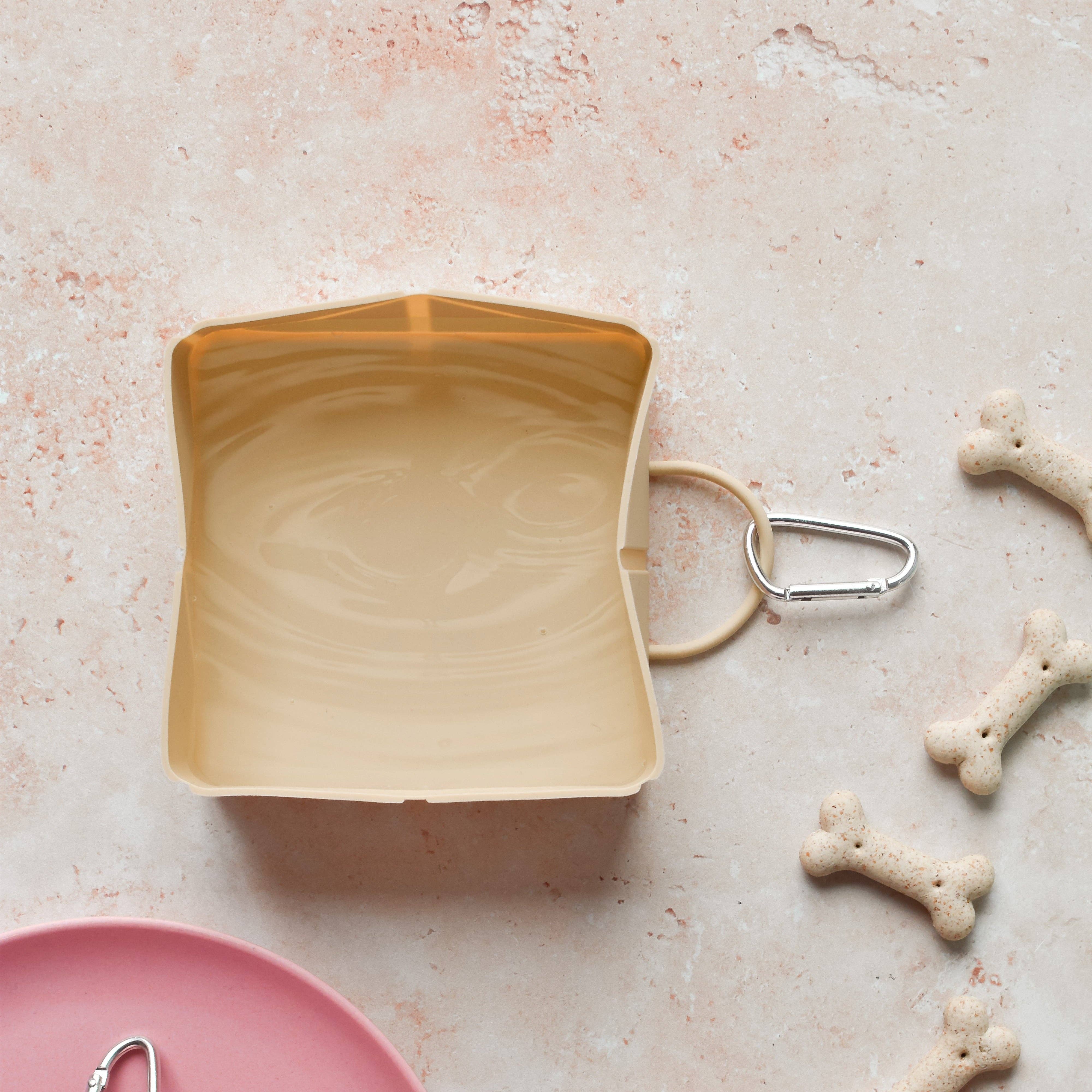 Foldable Travel Bowl in Nude used during a dog walk