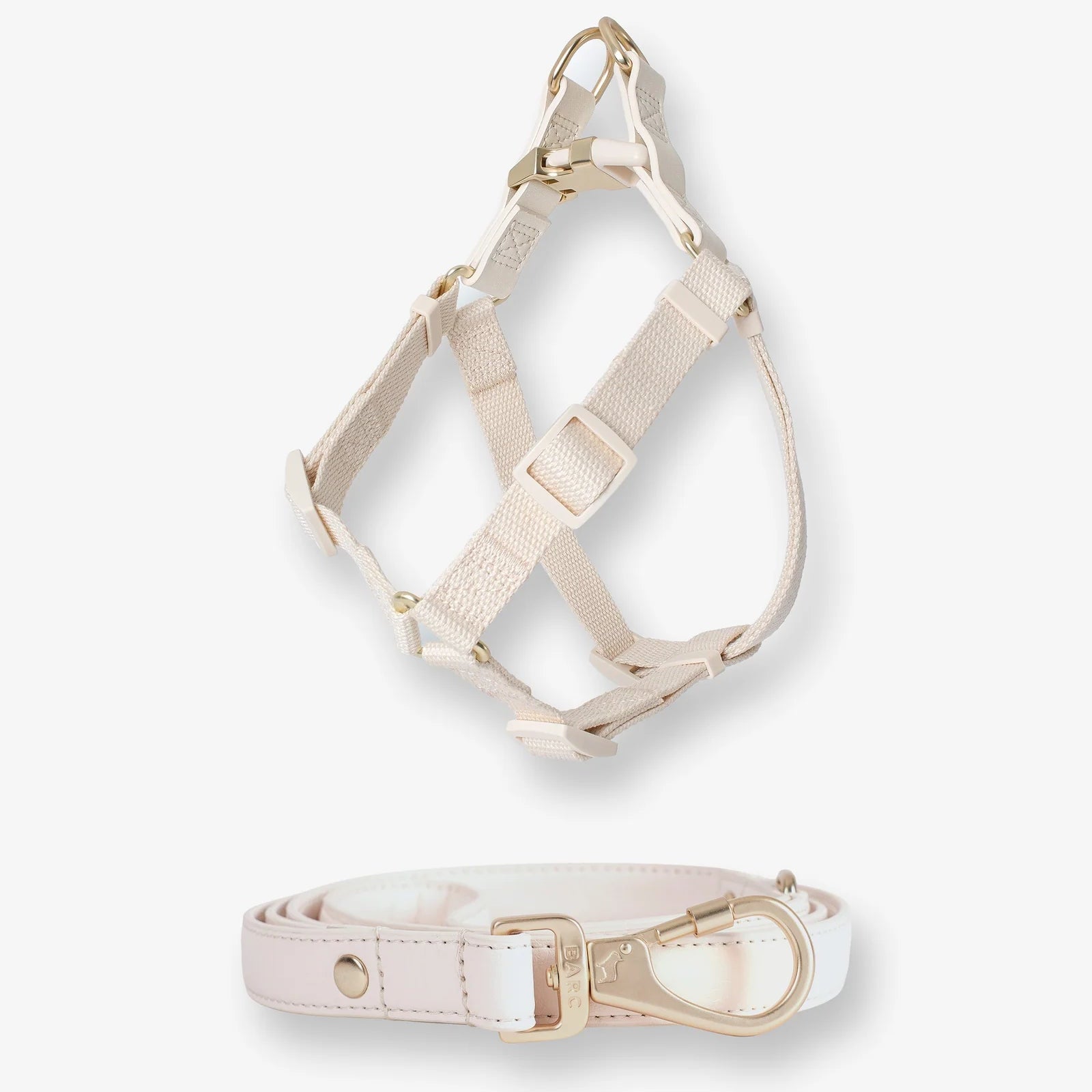 Beige dog harness and collar set on a white background