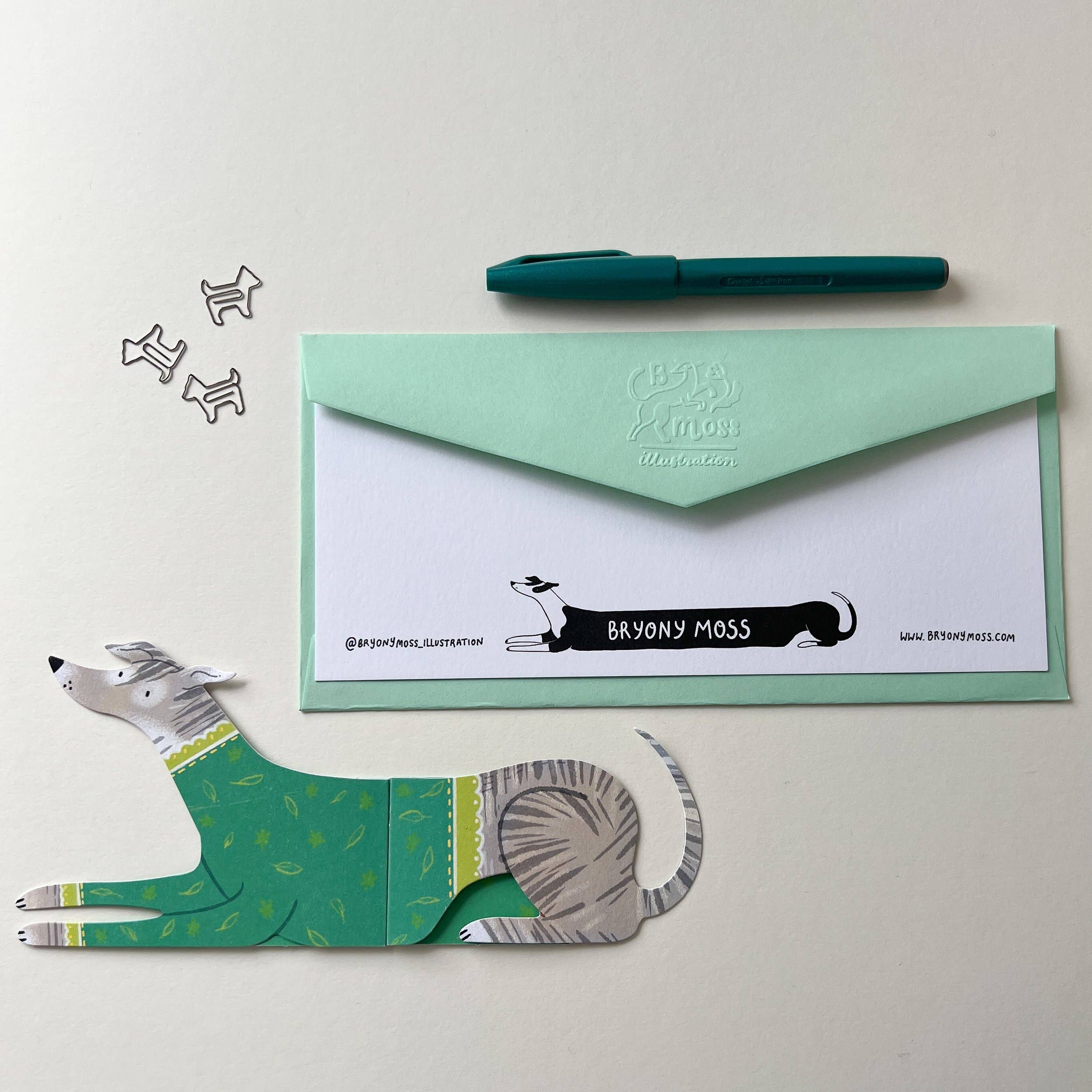 Green envelope with a dog illustration and 'Bryony Moss' branding on a white background.