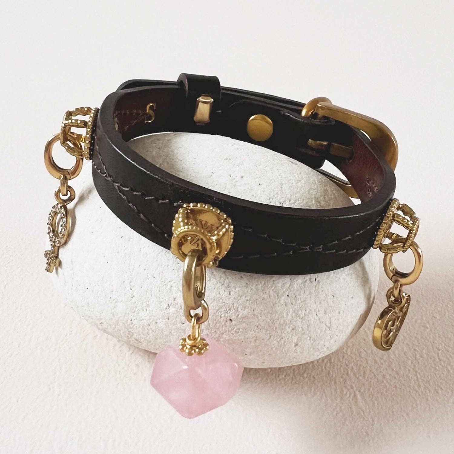 Close-up detail of the Unleash rose quartz charm