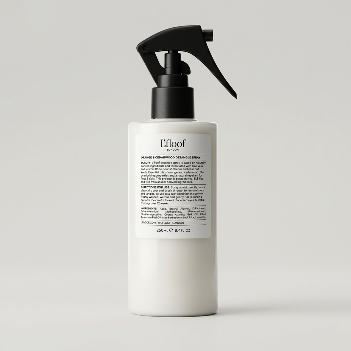 White spray bottle with black nozzle on a light gray background