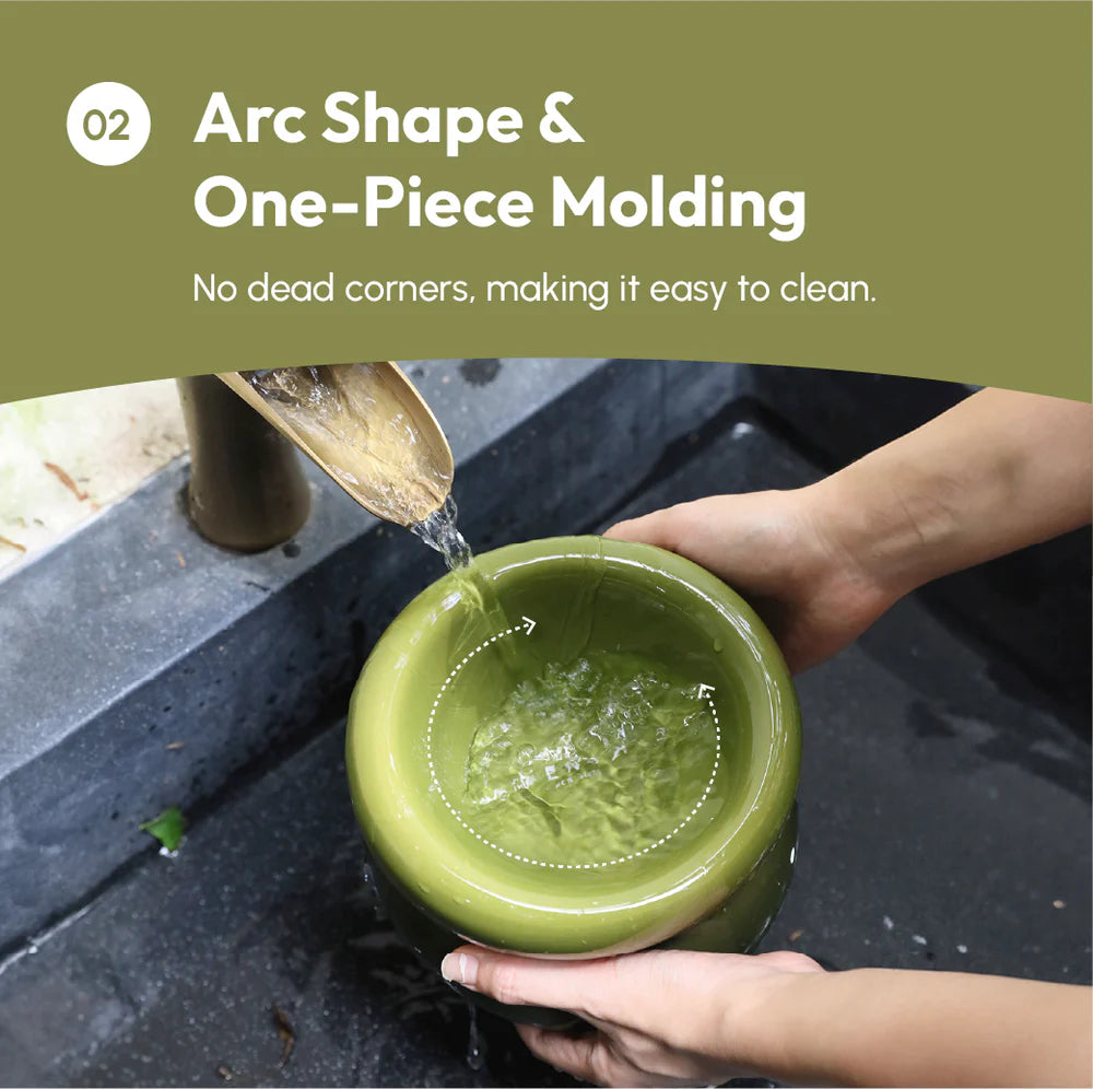 Person pouring water into a green ceramic bowl with text about arc shape and one-piece molding.