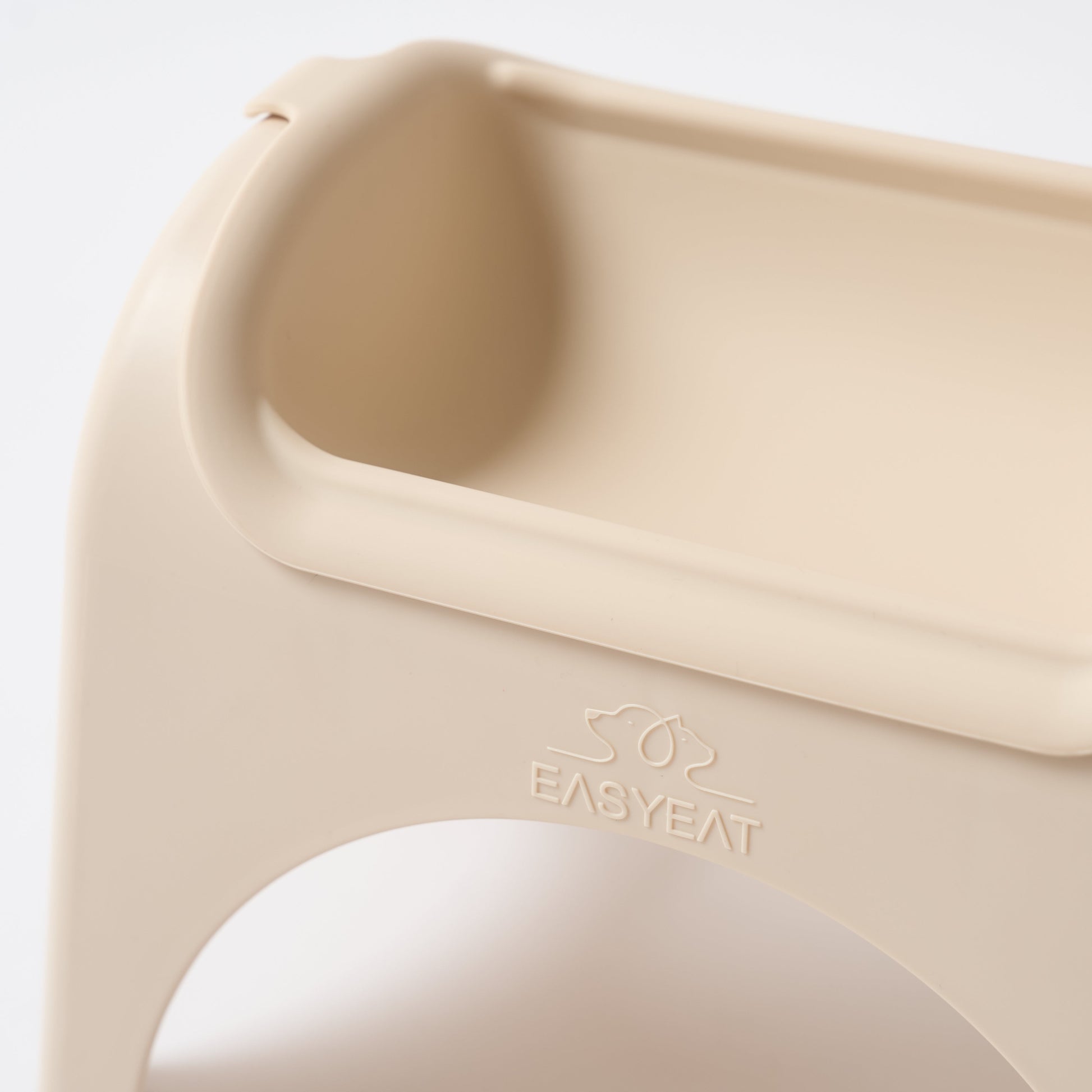Beige baby bib with 'EASYEAR' branding on a light gray background