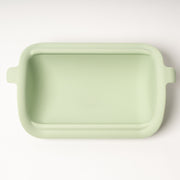 Light green rectangular ceramic dish on a white background