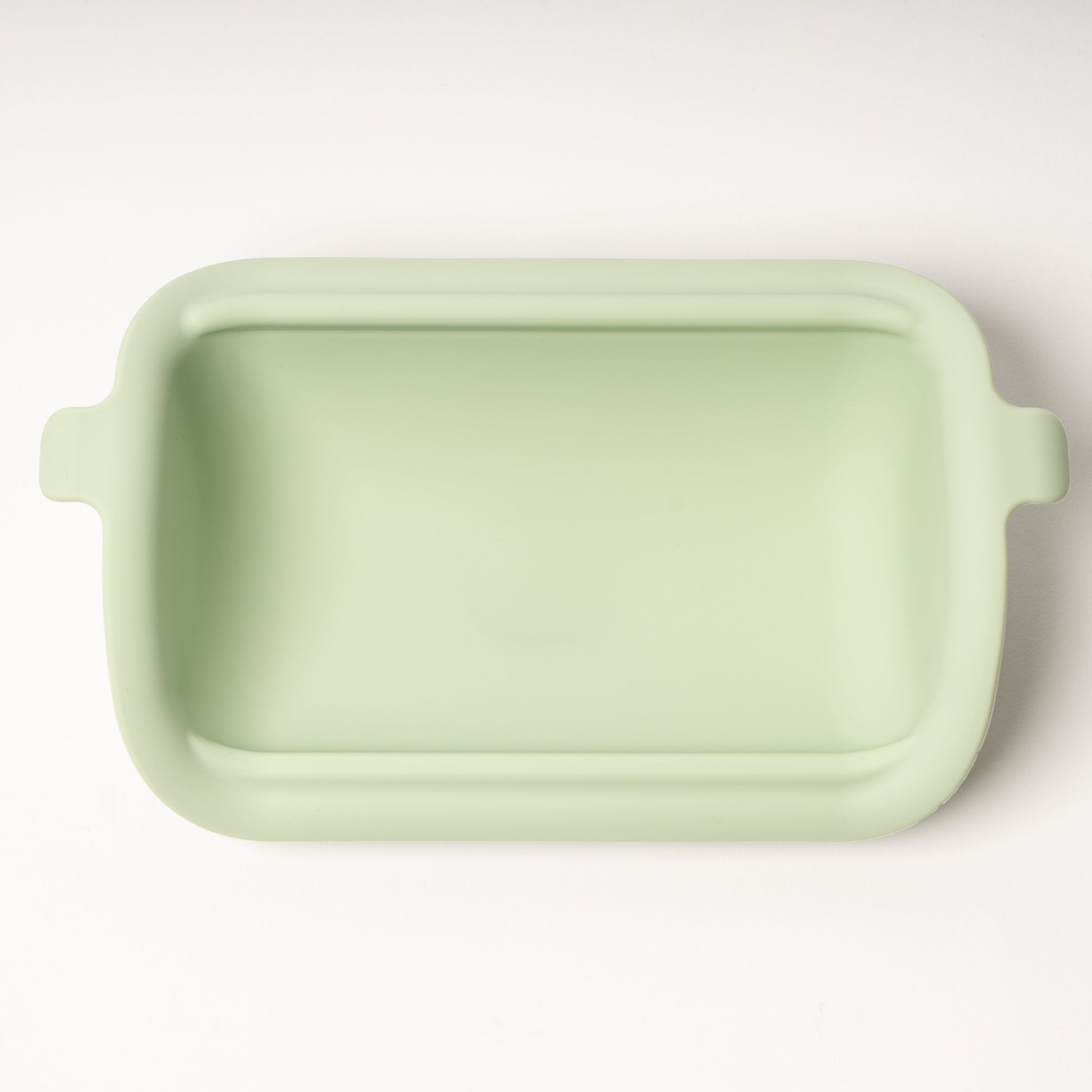 Light green rectangular ceramic dish on a white background