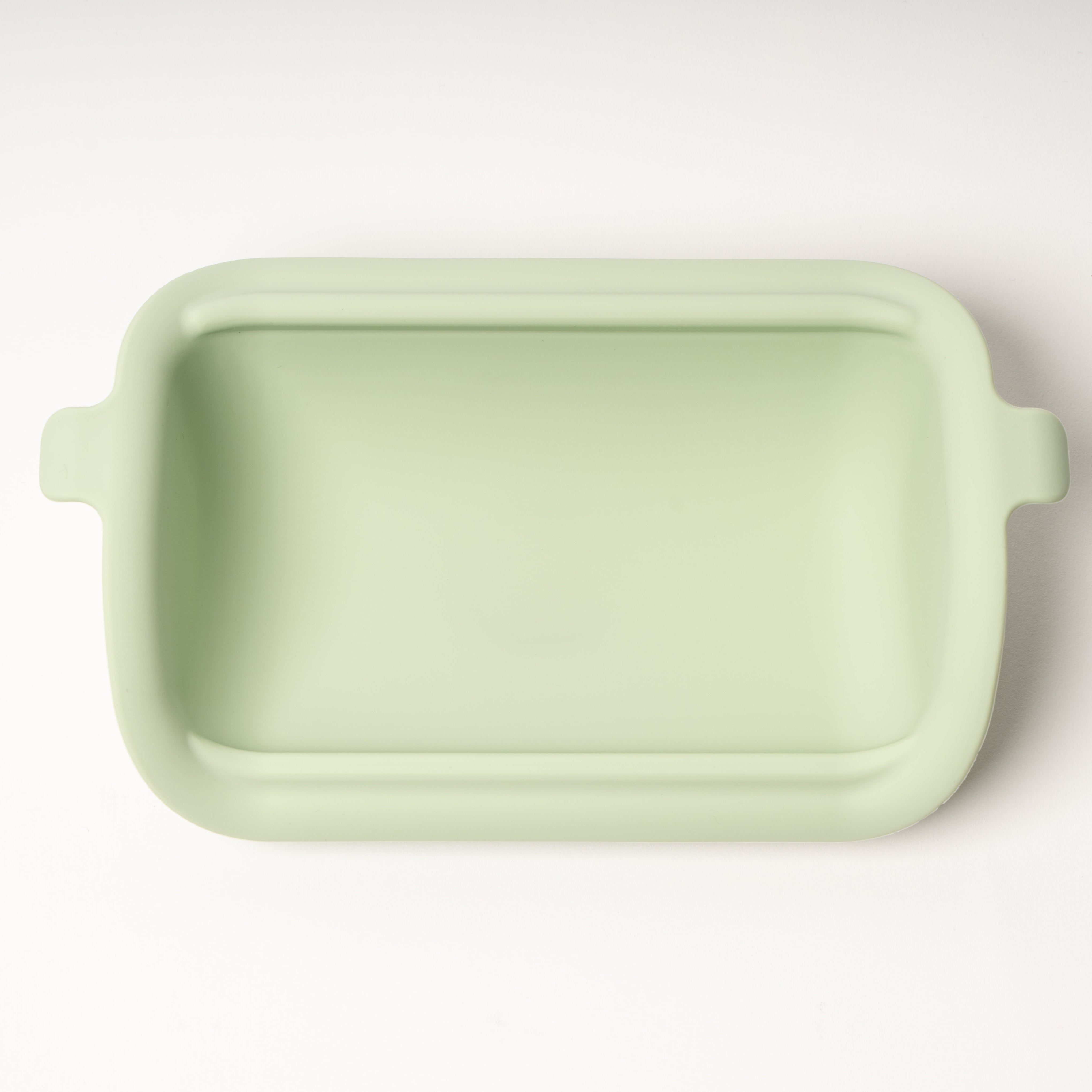 Light green rectangular ceramic dish on a white background