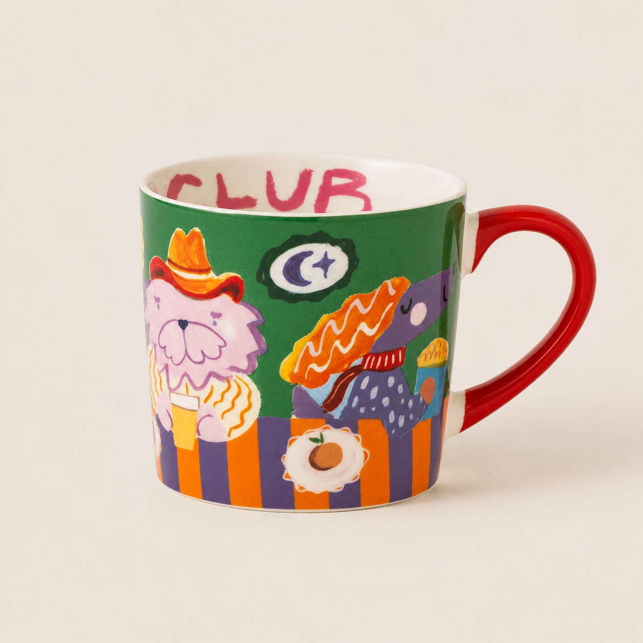 A ceramic coffee mug with a colorful, whimsical illustration of two cartoon dogs in a bar scene. The mug features a green background on the printed design, a red handle, and the word 'CLUB' written in pink on the interior rim, set against a plain beige background.