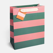 Striped gift bag with pink and green stripes on a white background