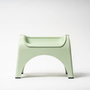 Light green plastic chair on a white background