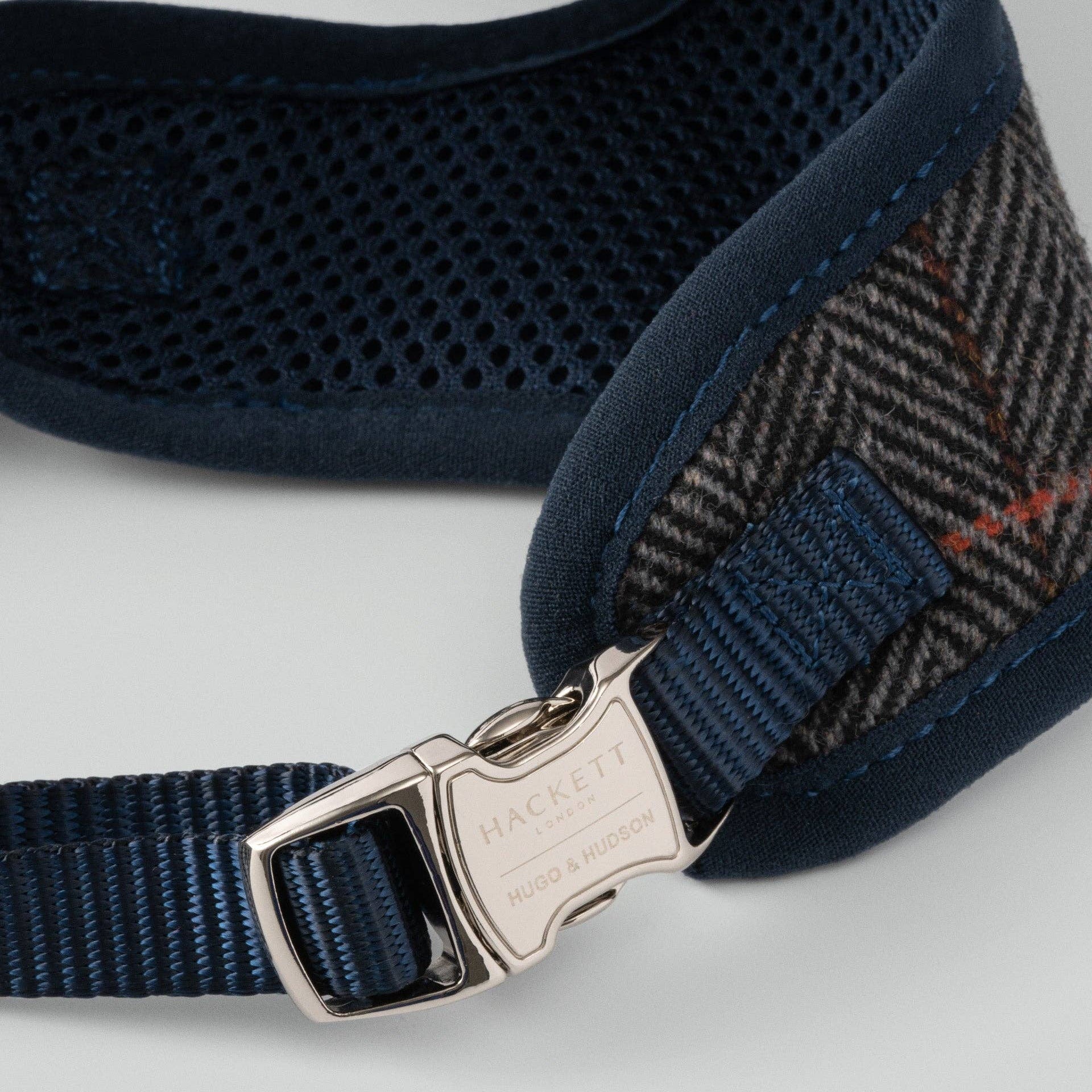 Close-up of the grey herringbone tweed fabric and premium stitching