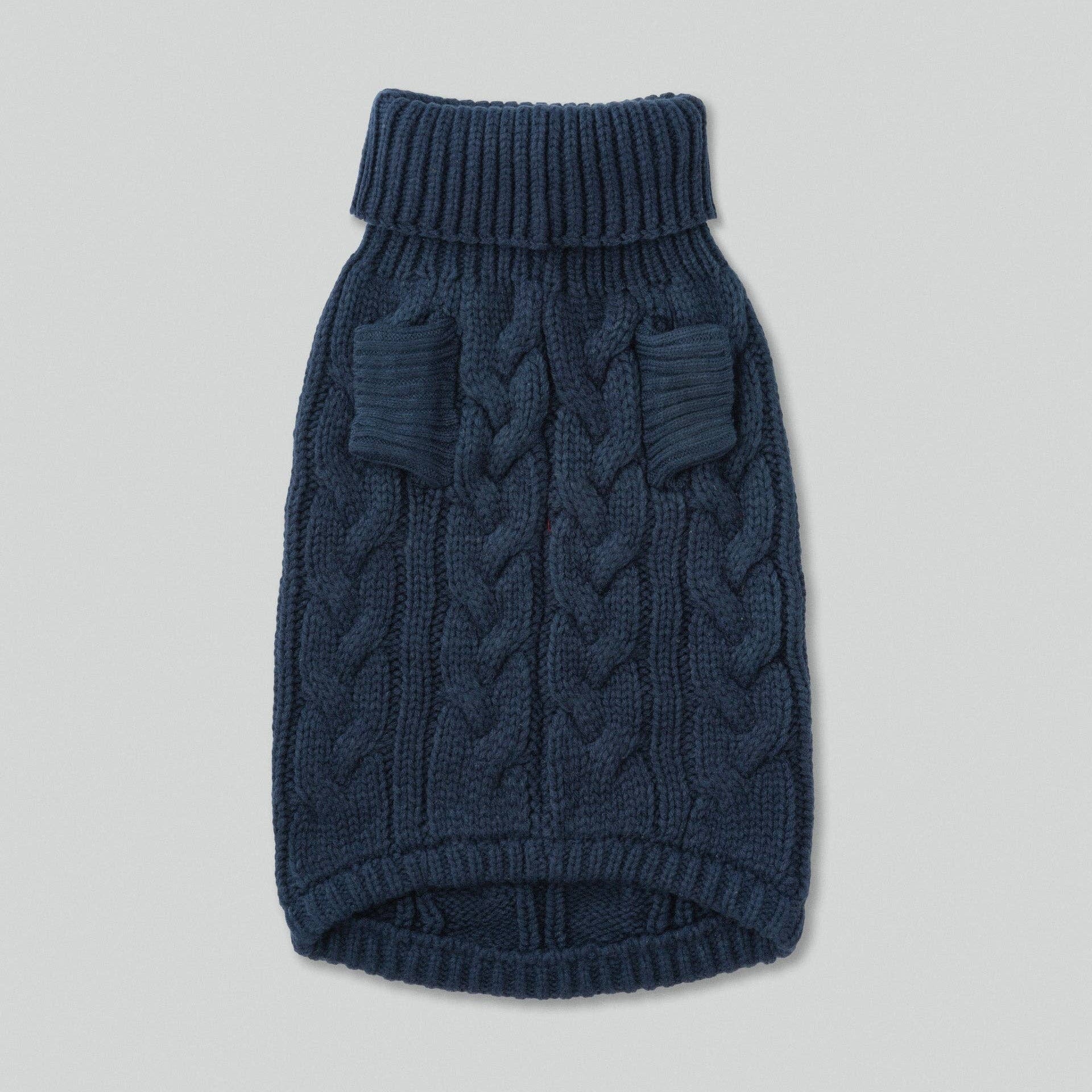 Blue knitted dog sweater on a light gray background