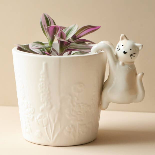 Ceramic cat planter hanger styled with indoor plants