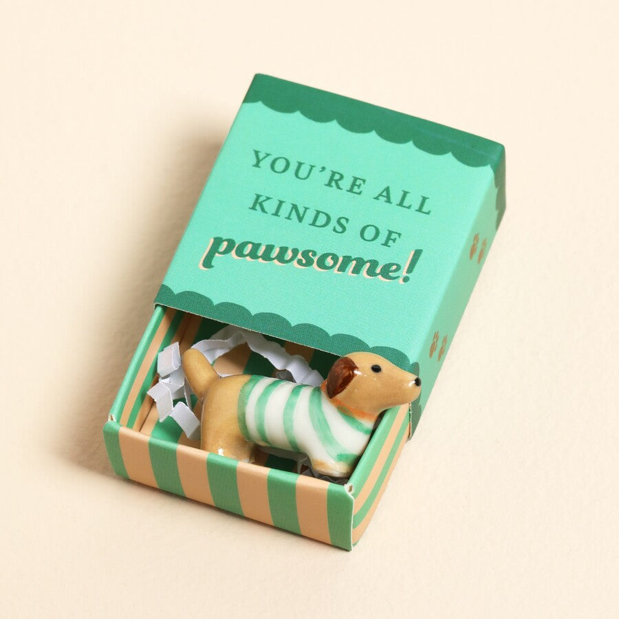 Close-up of the tiny ceramic sausage dog token
