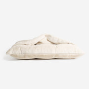 Sleepy Burrows Bed in Cream Faux Fur styled inside a dog crate