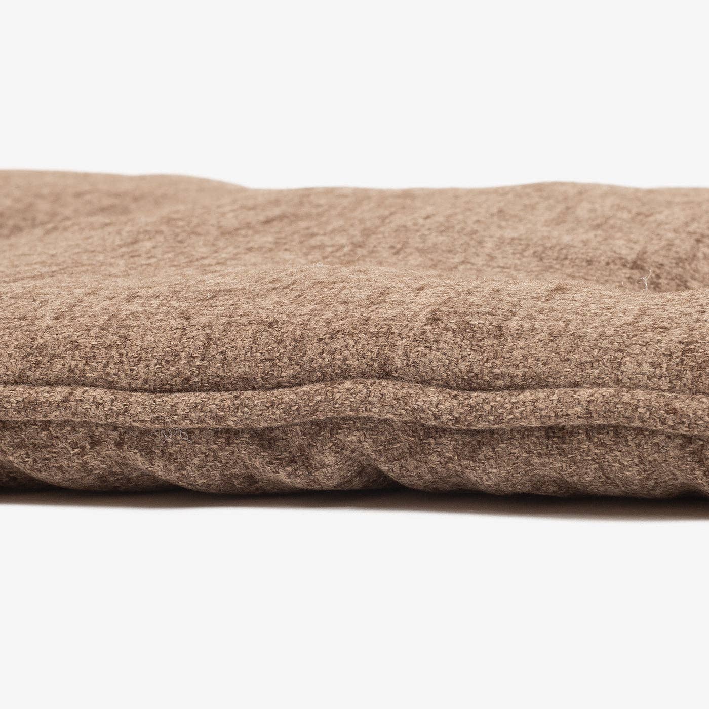 Close-up of a brown cushion on a white background