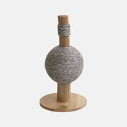 Cat toy with a spherical rope ball and wooden base on a white background