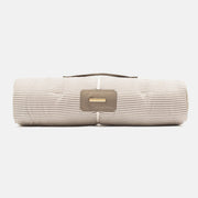 Striped fabric roll with a gold logo on a white background