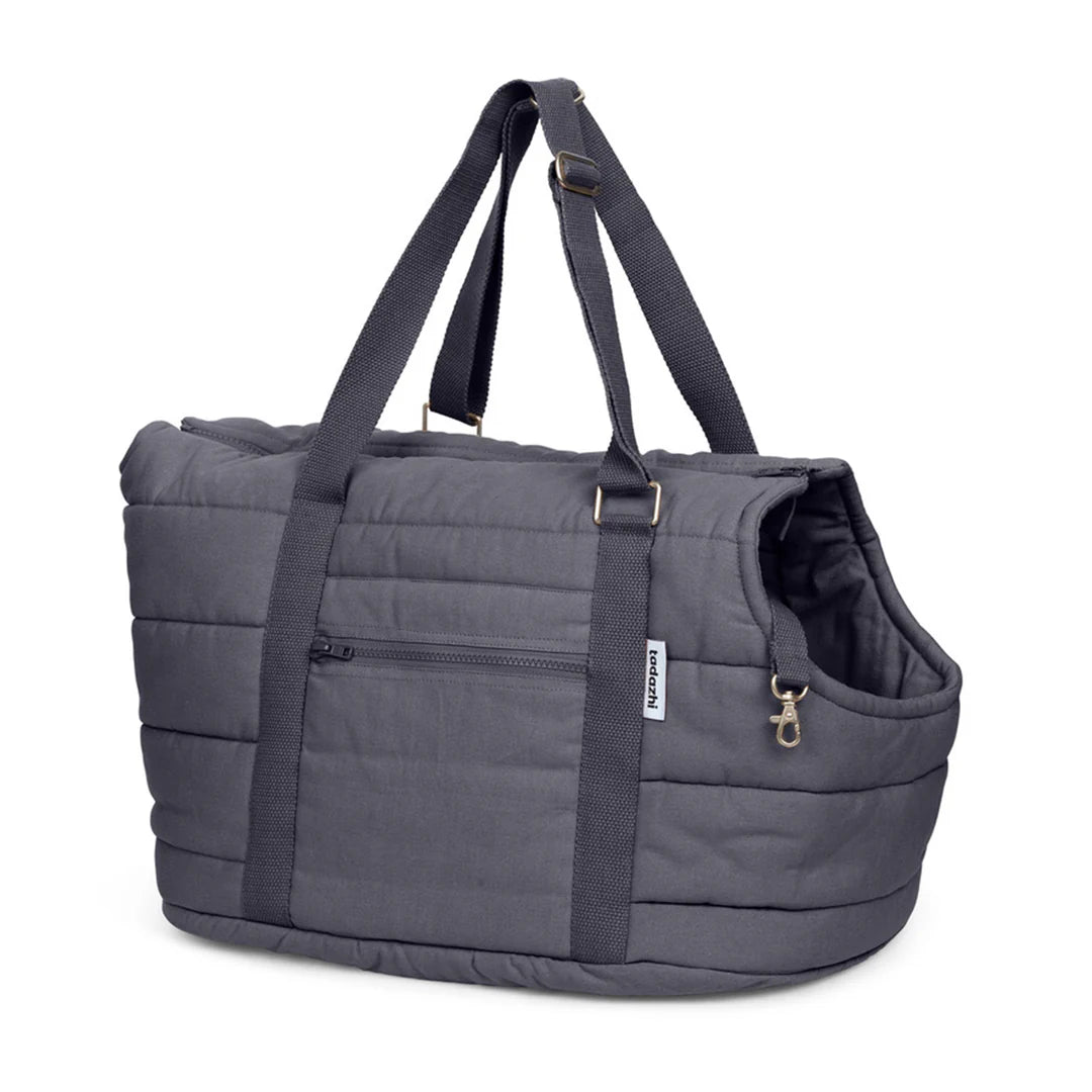 Gray quilted duffel bag with a handle on a white background