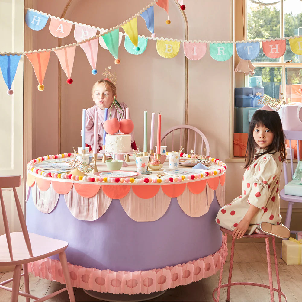 Children's birthday party setup with a decorated table and colorful decorations.