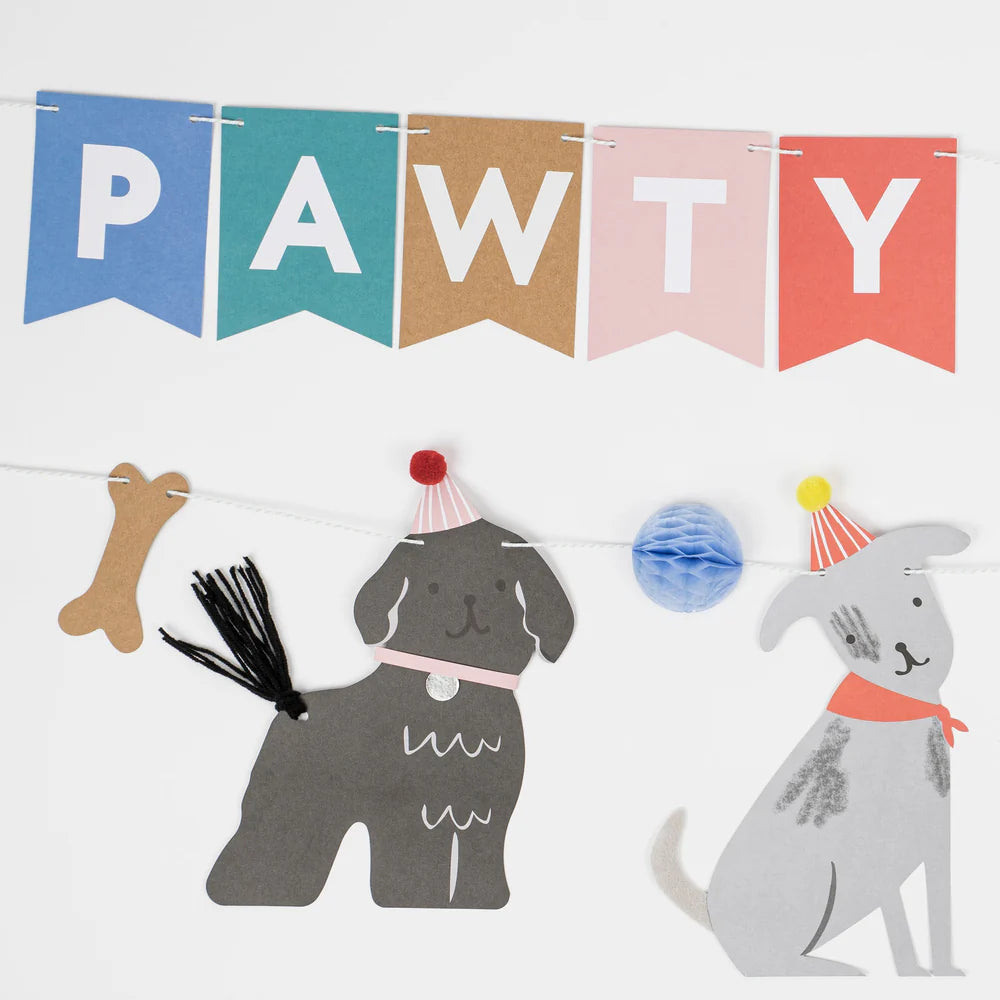 Dog-themed party decorations with 'PAWTY' banner, dog cutouts, and party hats on a white background.
