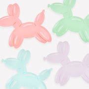 Four pastel-colored balloon dog figures on a white background
