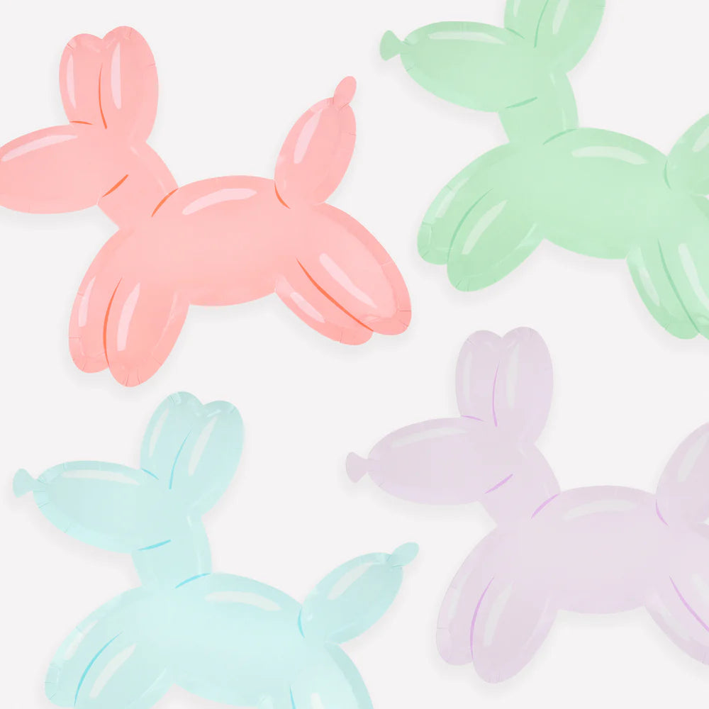 Four pastel-colored balloon dog figures on a white background