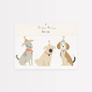Three cartoon dogs wearing party hats on a white background with 'Meri Meri' branding.