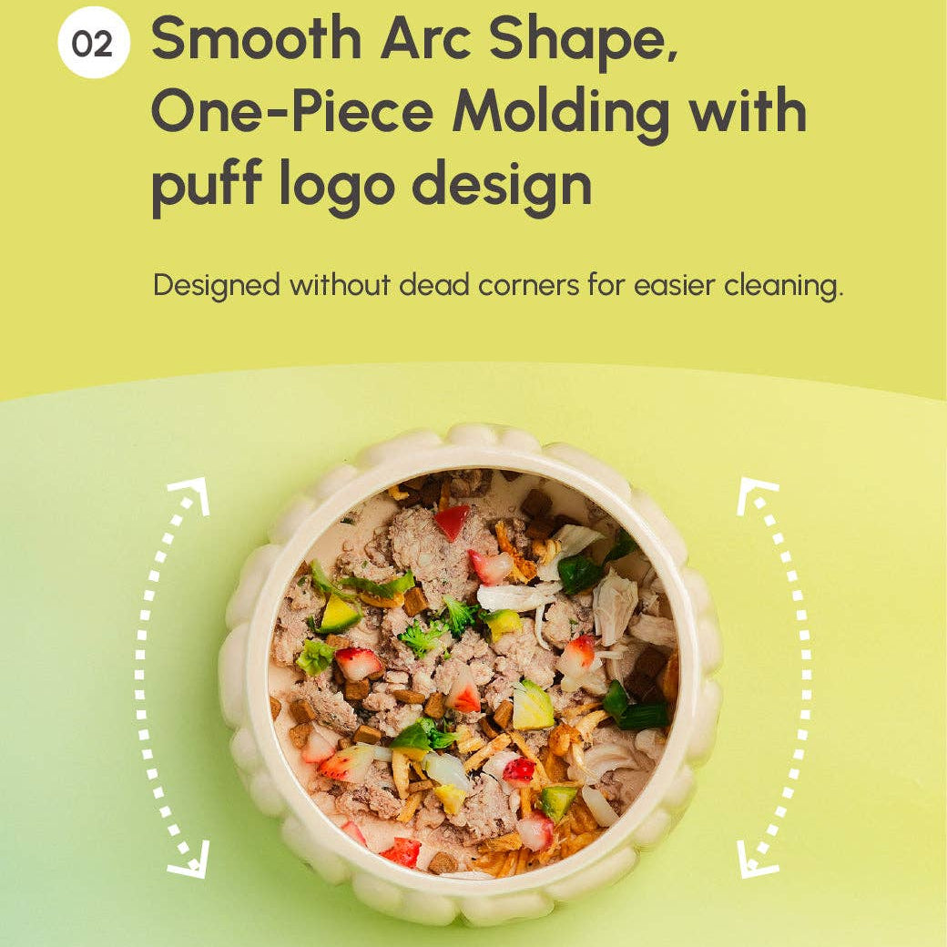Pet food bowl with smooth arc shape and one-piece molding on a green background