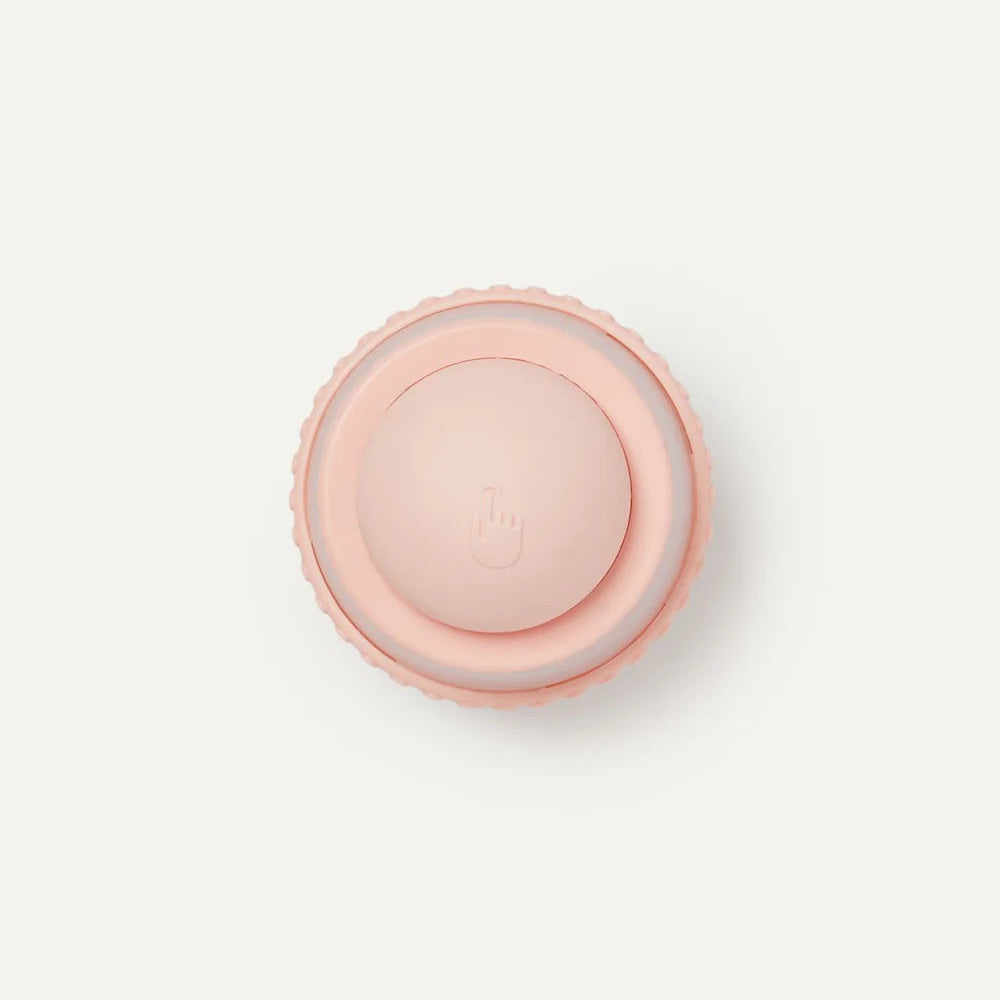 Pink round object on a light pink background