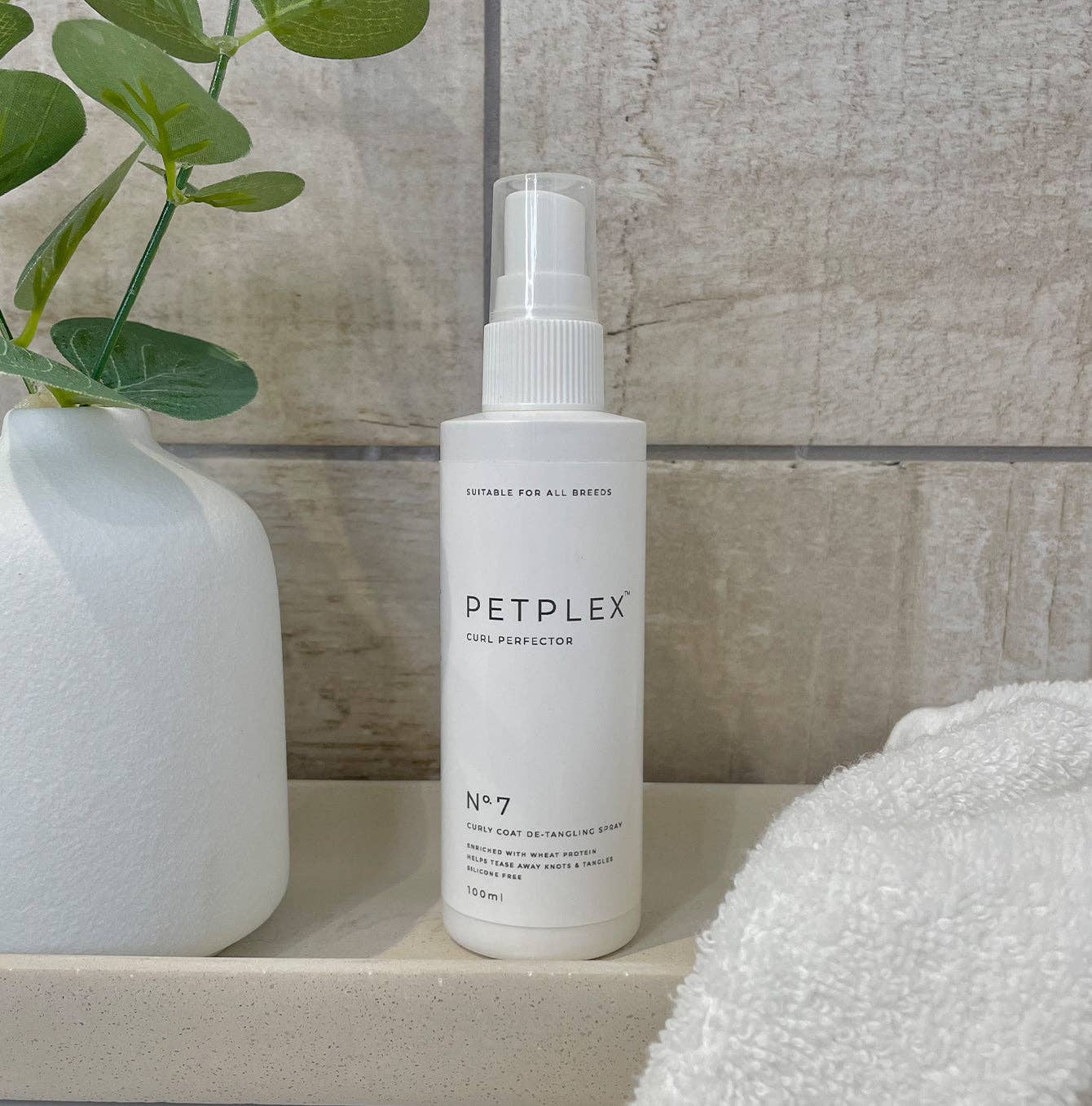 Close-up of the PetPlex Curl Perfecter Detangling Spray bottle