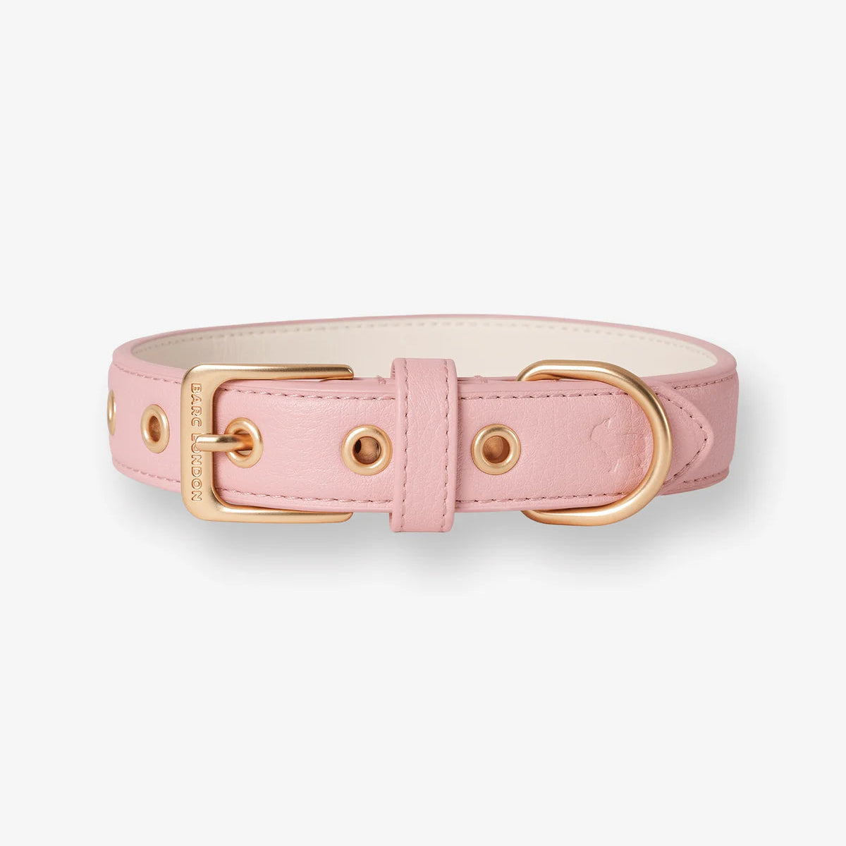 Pink dog collar with gold hardware on a white background