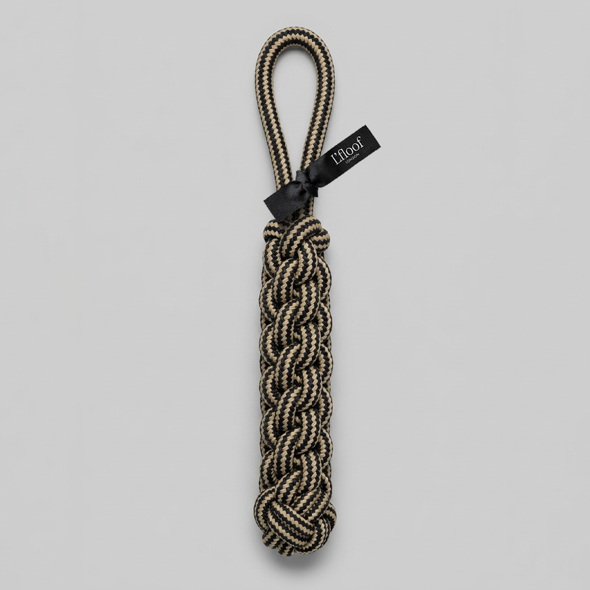Nylon dog rope toy with a black tag on a light gray background