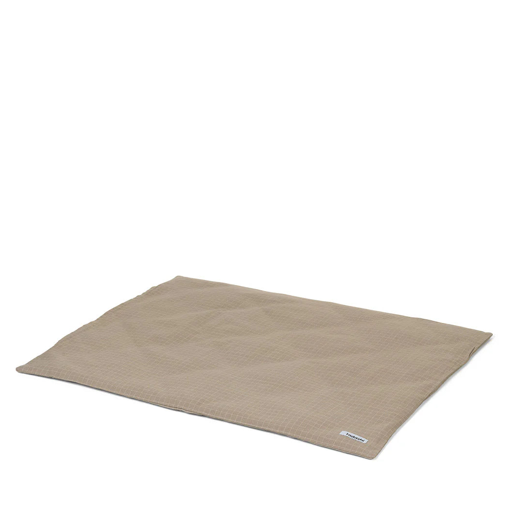 Beige dog bed on a white background