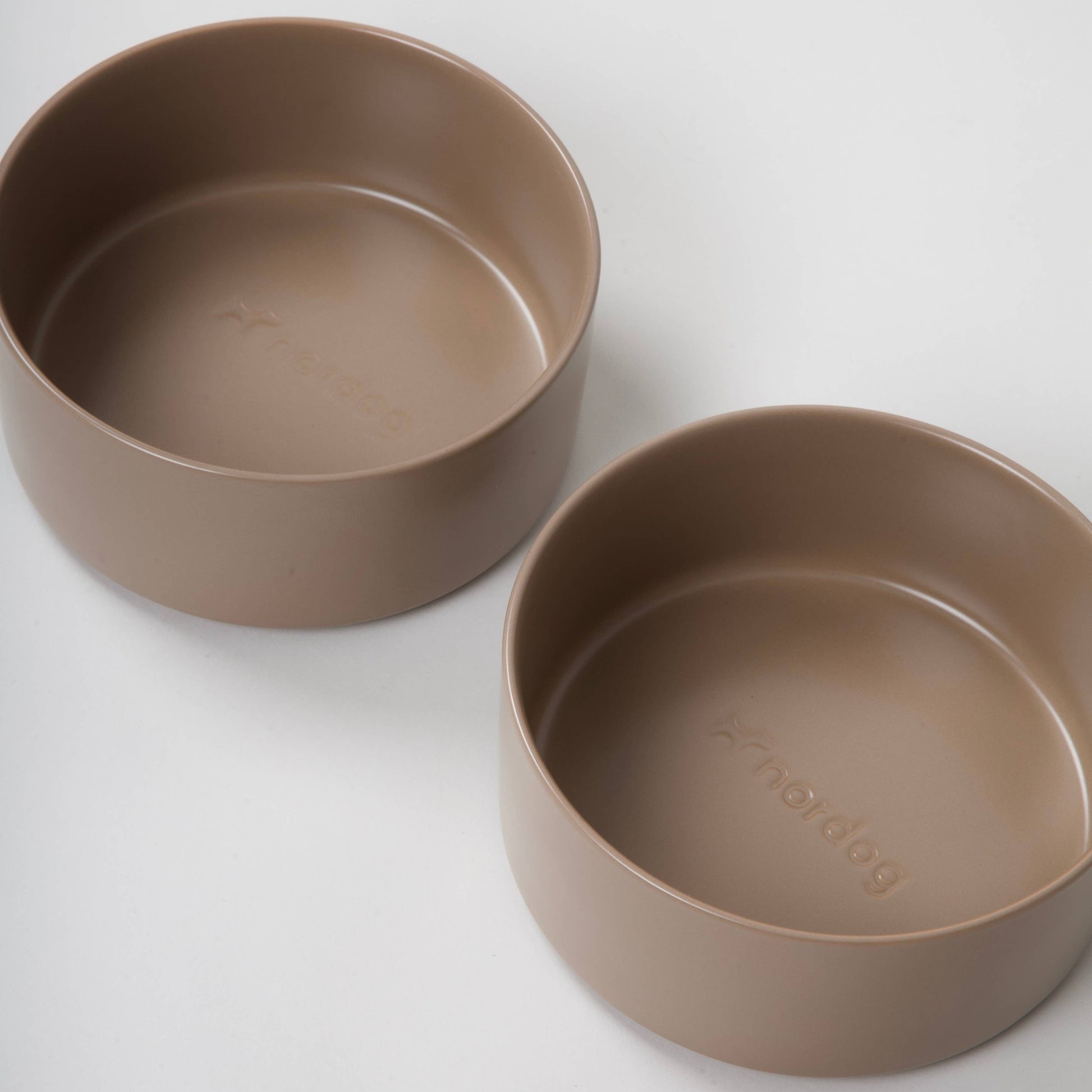 Two brown ceramic bowls on a white background