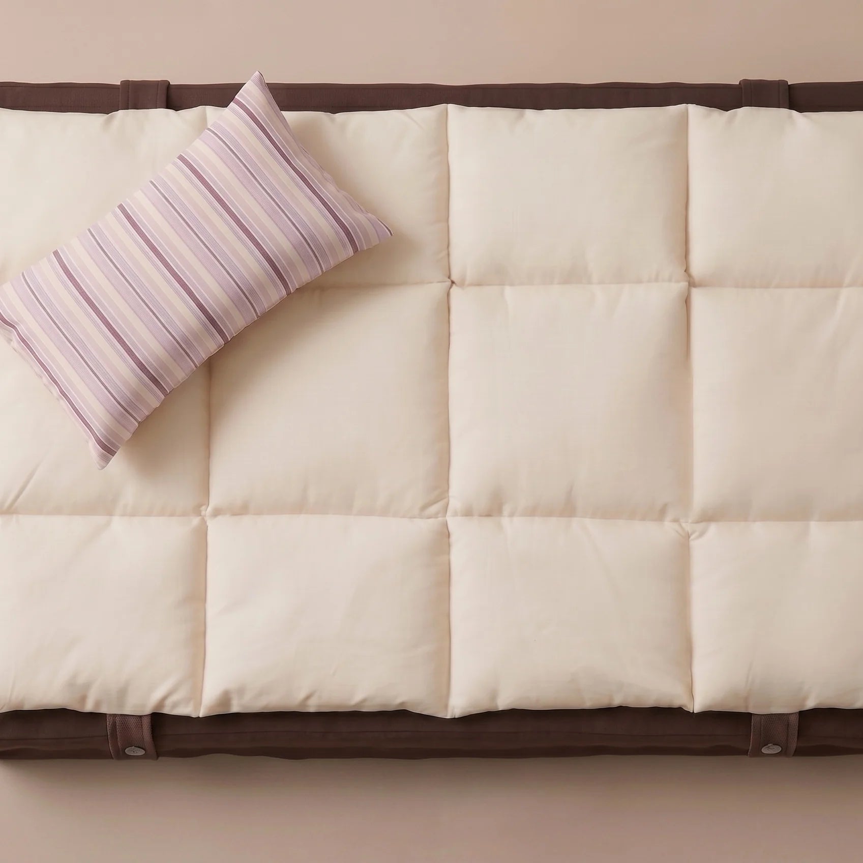 Luxury chocolate brown dog bed with contrasting quilted beige cushion.