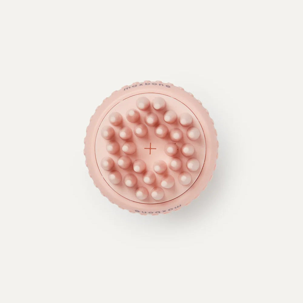 Pink silicone scrubber with textured surface on a white background
