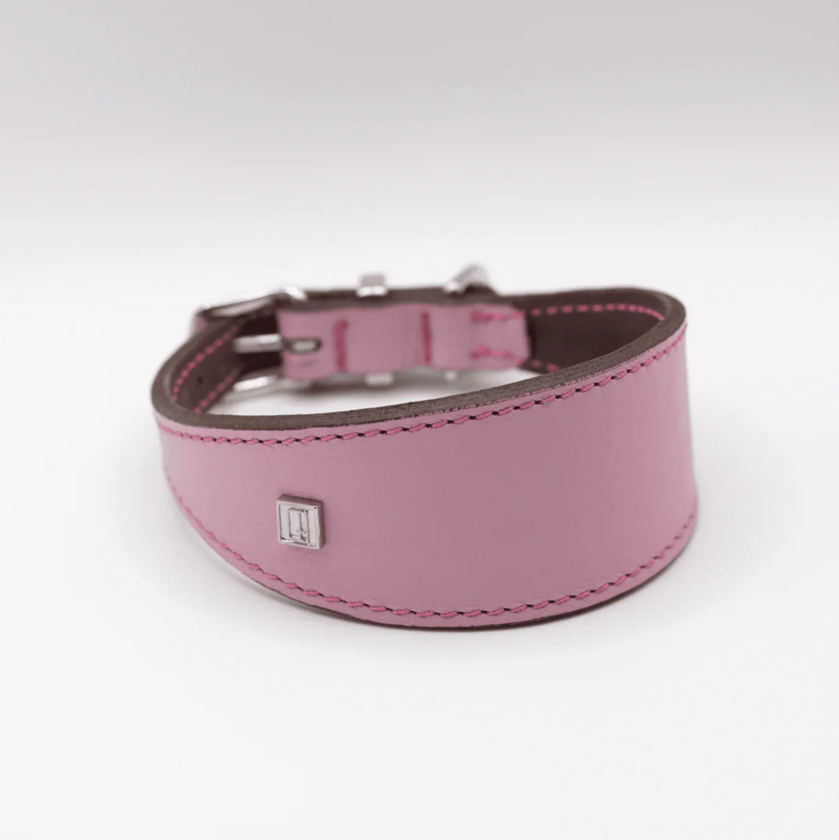 Pink leather dog collar with a silver buckle on a white background