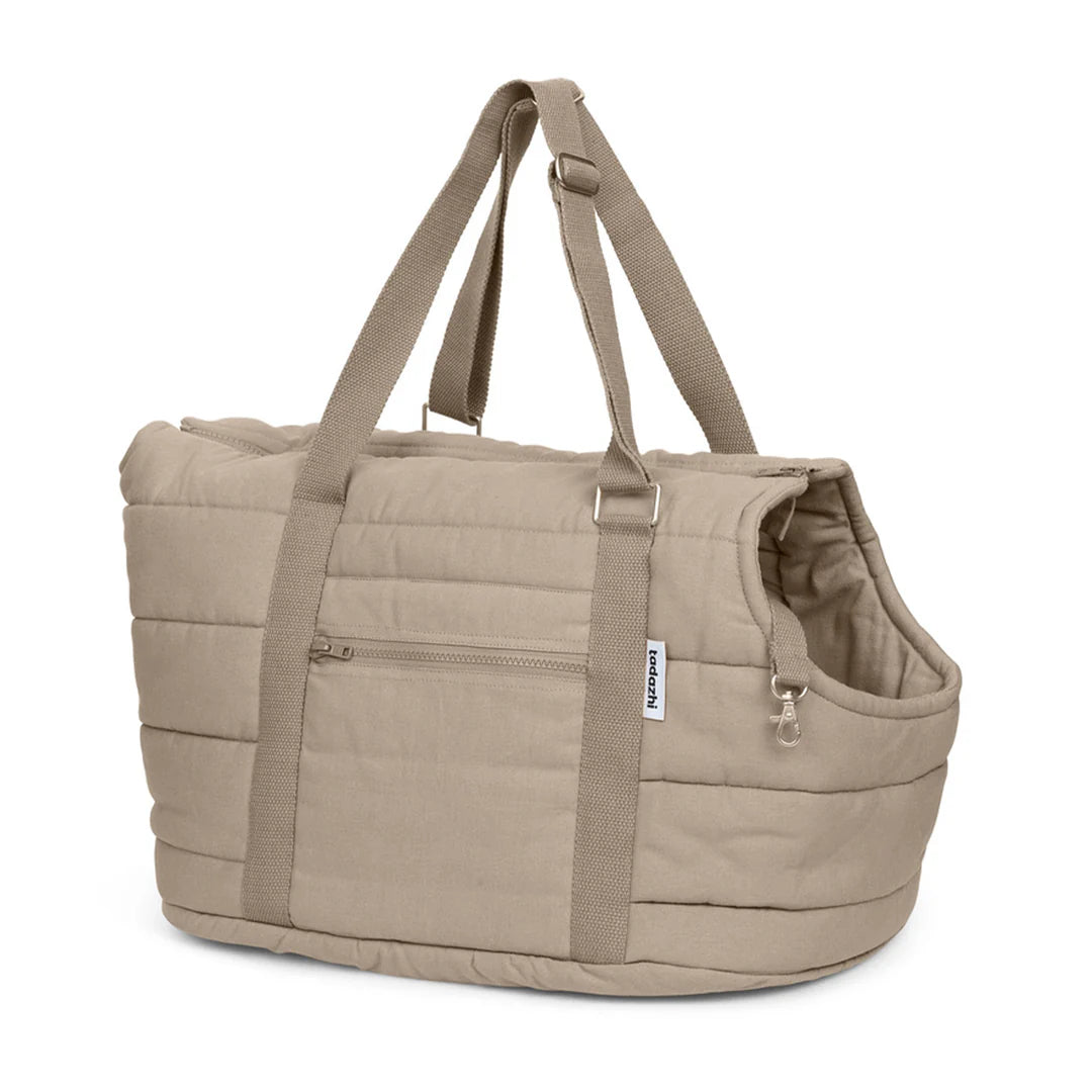 Beige pet carrier with straps on a white background