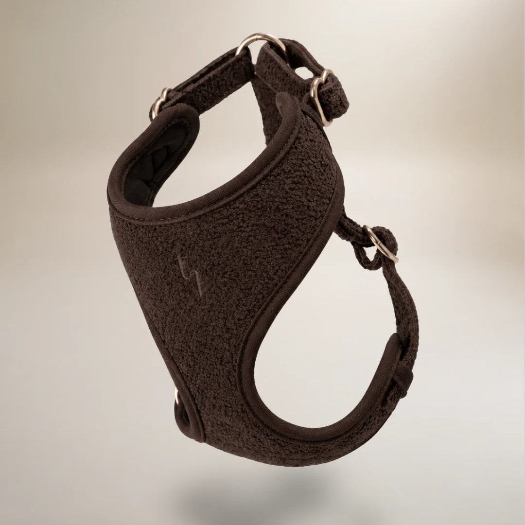 Brown dog harness on a light gray background