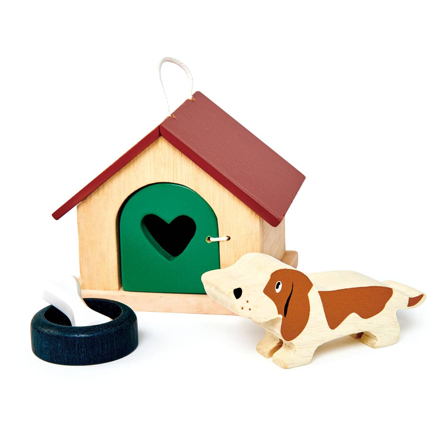 Wooden doghouse with a heart-shaped door, a dog toy, and a tire on a white background