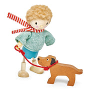 Wooden toy figure of a child with a dog on a white background