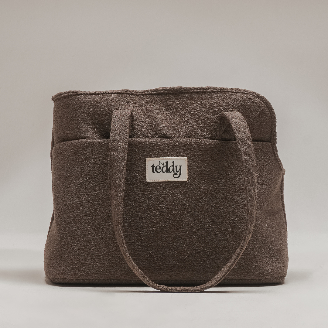 Brown textured tote bag with 'the teddy' logo on a light gray background