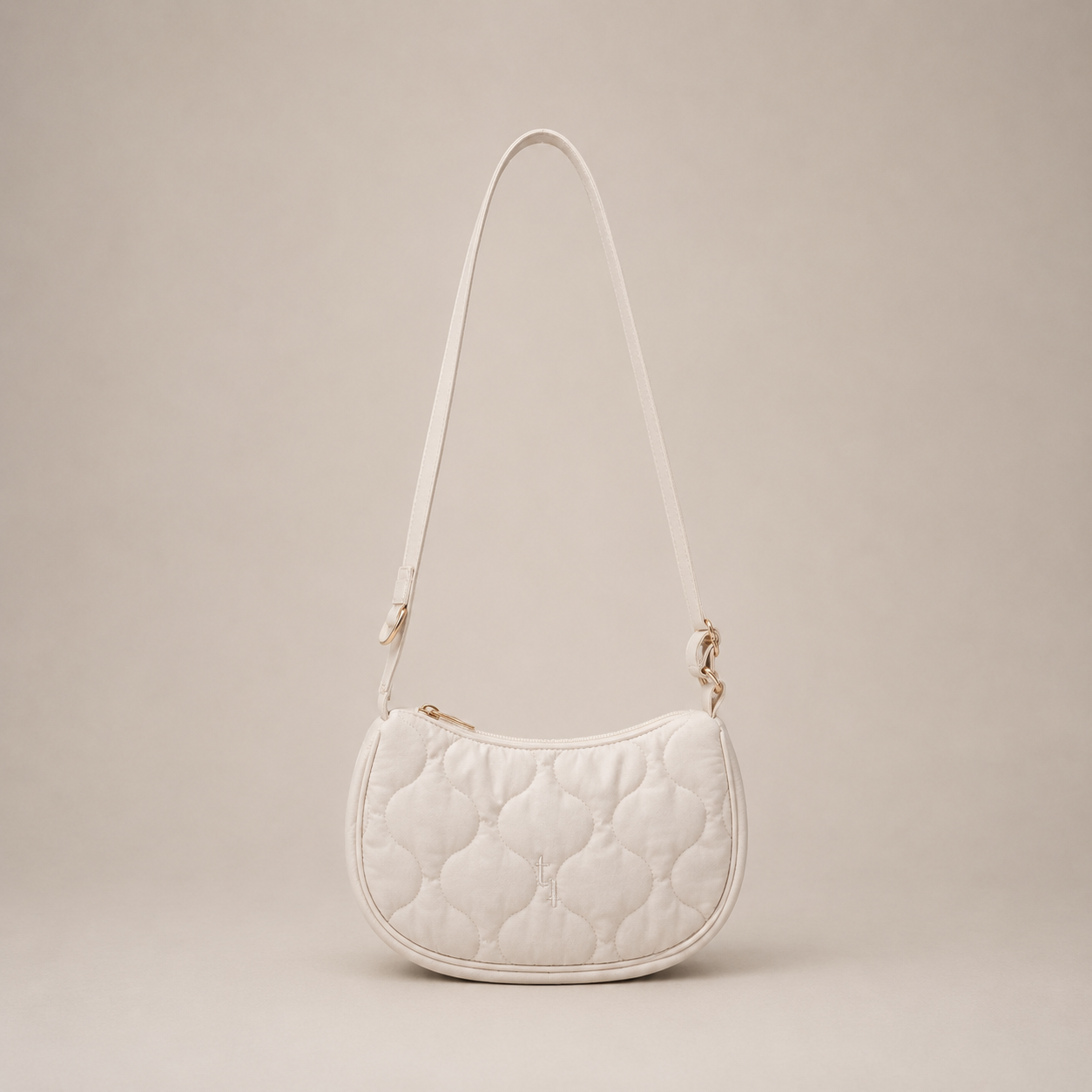 White quilted handbag on a beige background