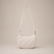 White quilted handbag on a beige background